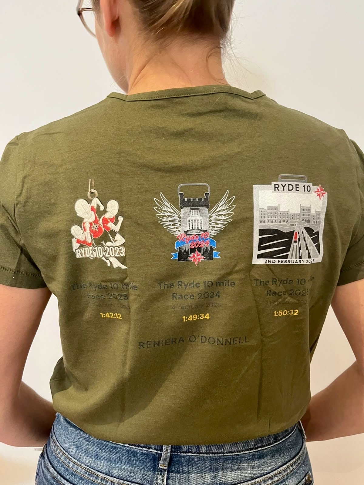 Three Ryde 10 medals from 2023, 2024 and 2025 printed on the back of an olive green T-shirt